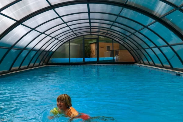 Kid at Bates Drive Public School enjoy swimming after installation of custom Klasik pool enclosure.